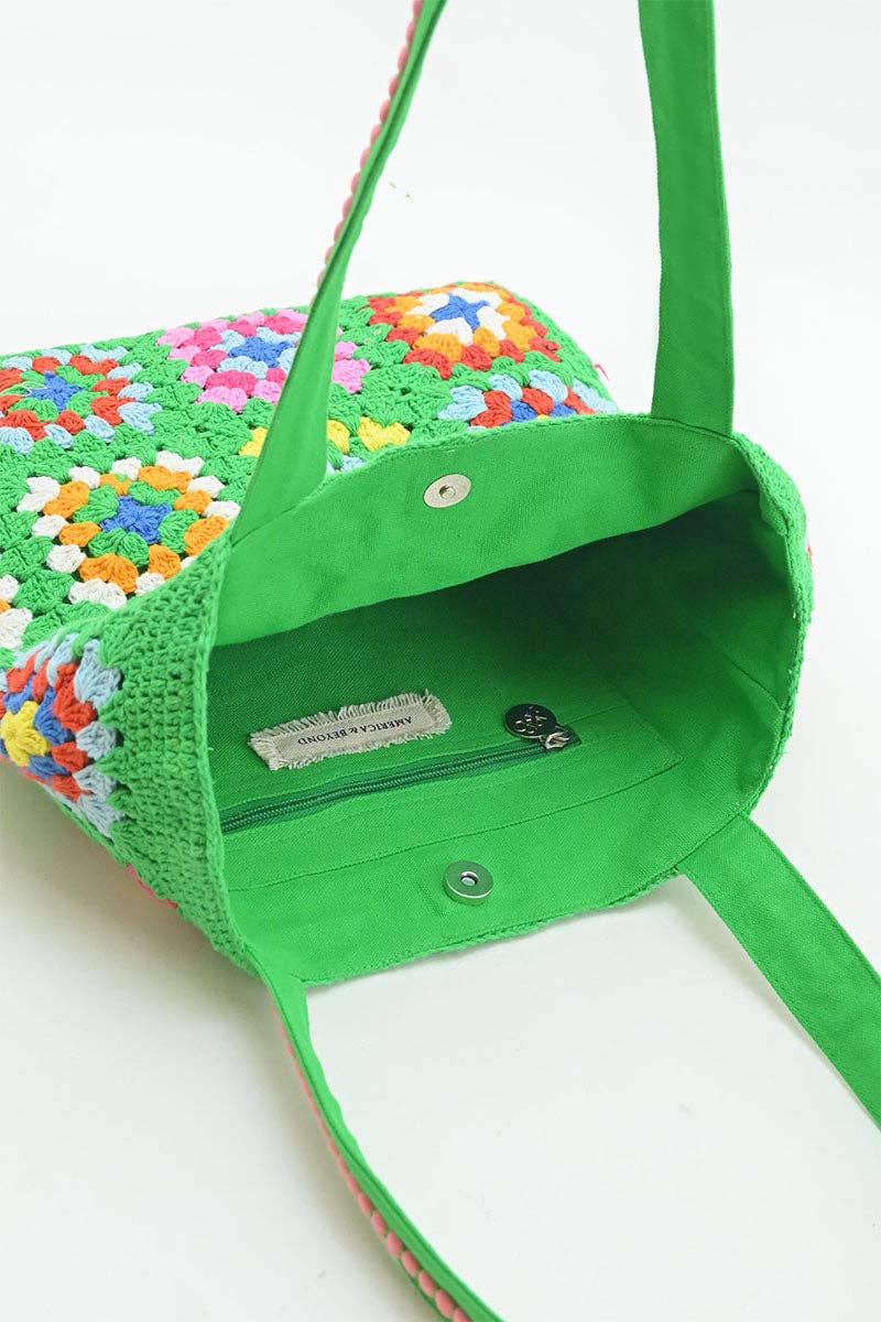 Green crochet bag with colorful pattern on a white background
