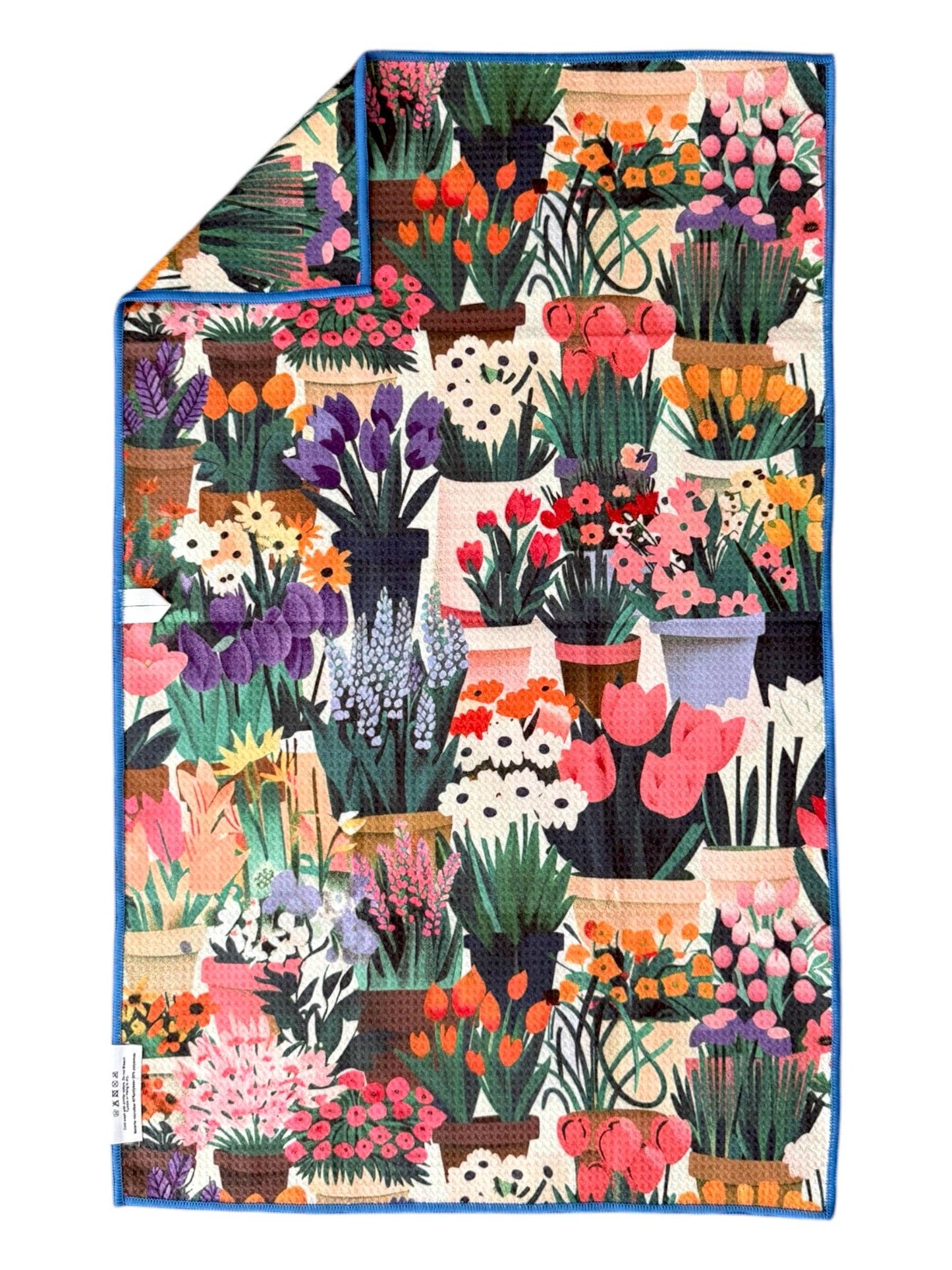 Colorful blanket with floral and potted plant pattern on a white background