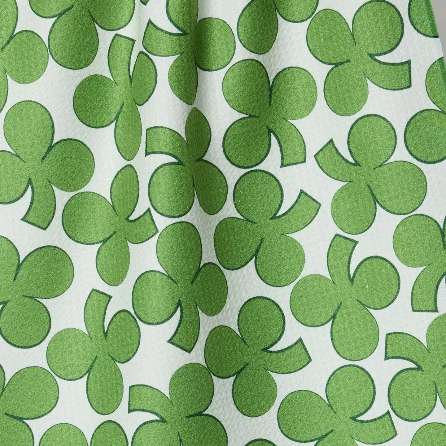 Pattern of green shamrocks on a white background