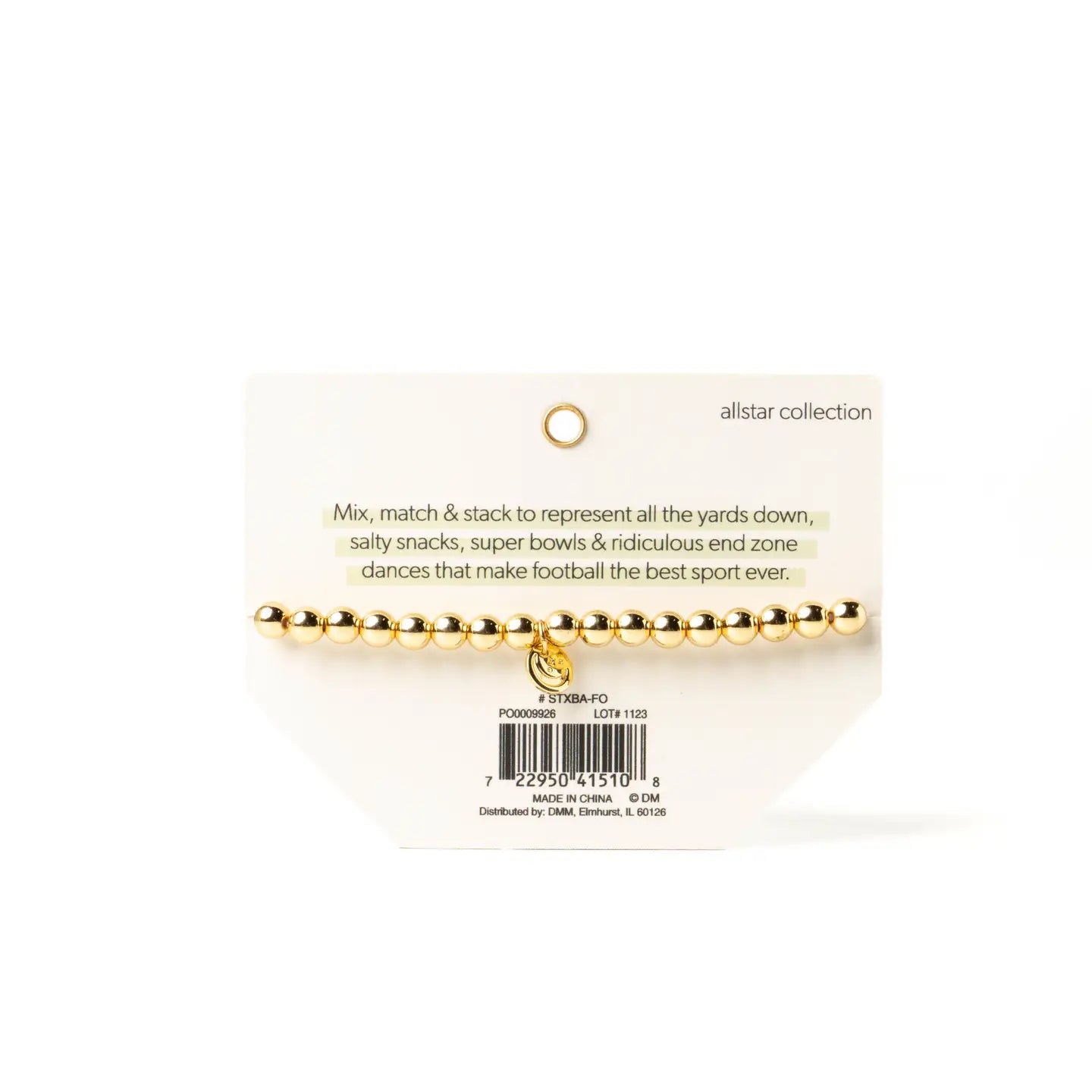 A gold beaded bracelet with a small dangling charm, displayed on a white retail card labeled 'allstar collection' against a white background.