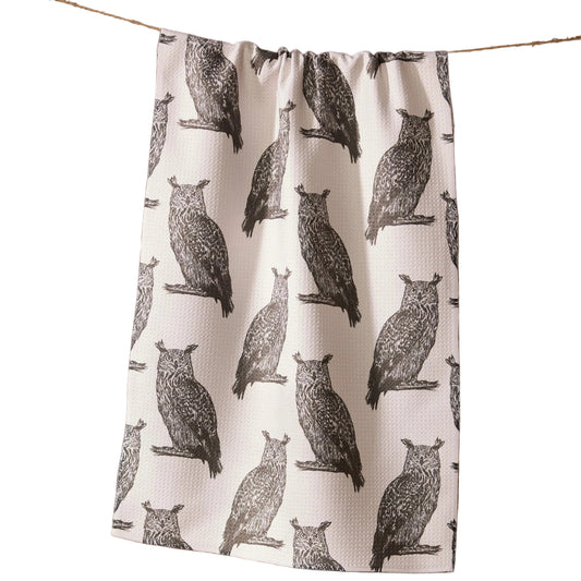 Tea towel with owl pattern hanging on a line against a white background