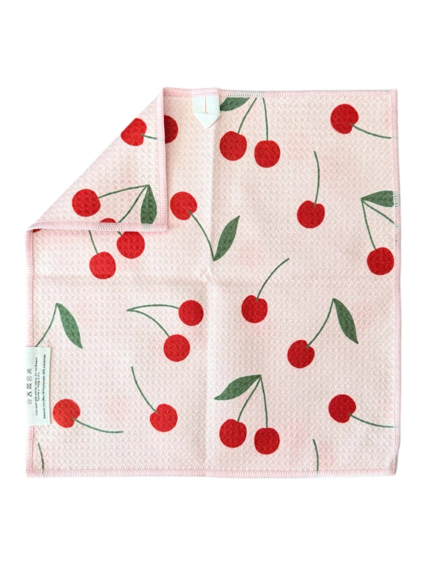 Folded towel with cherry pattern on a white background