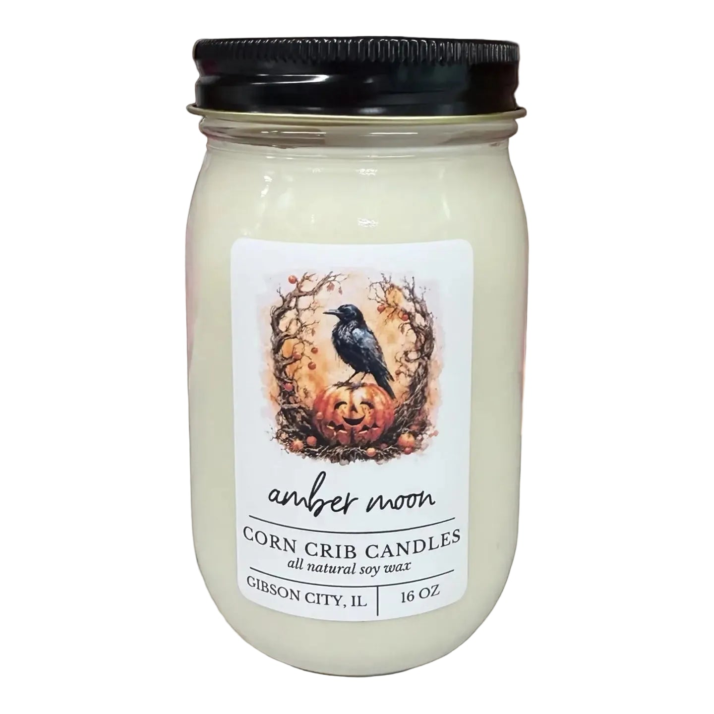 A 16 oz soy wax candle in a clear glass mason jar with a black lid, featuring a white label with a raven and pumpkin illustration. The label reads 'amber moon' and 'CORN CRIB CANDLES'.