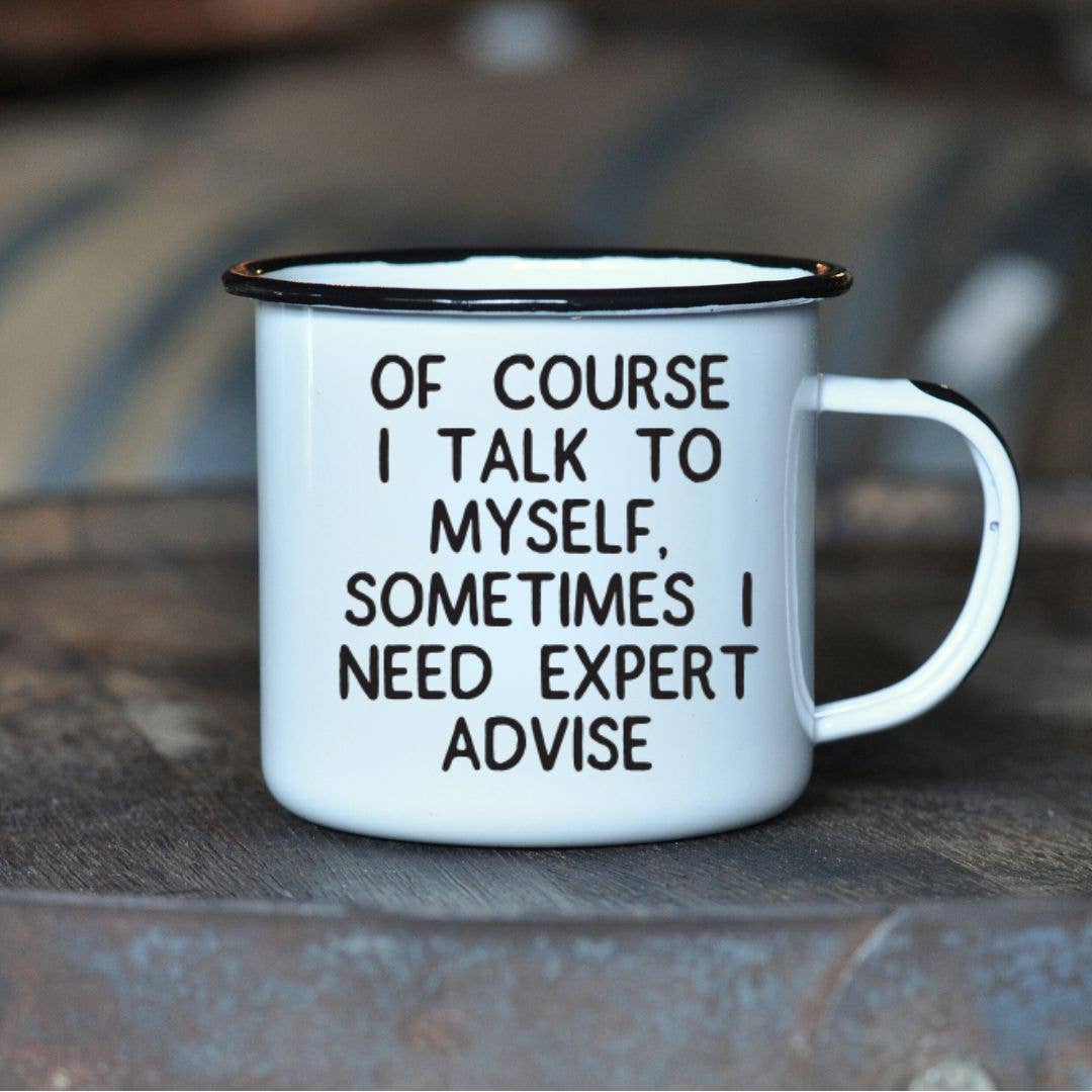 White mug with black text on a wooden surface