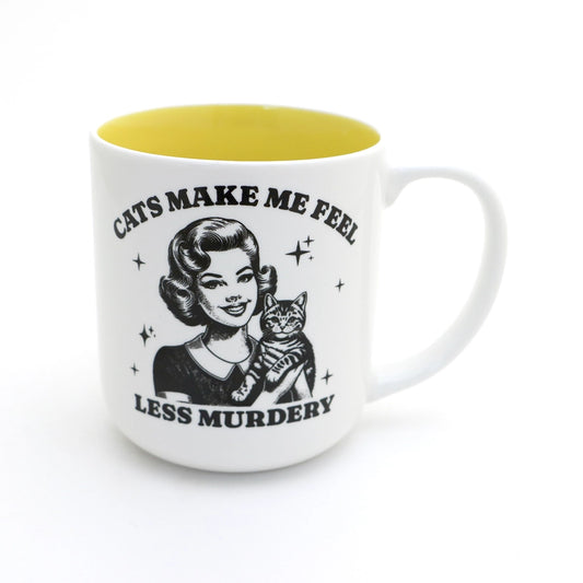 White and yellow mug with black vintage style graphics that read cats make me feel less murdery