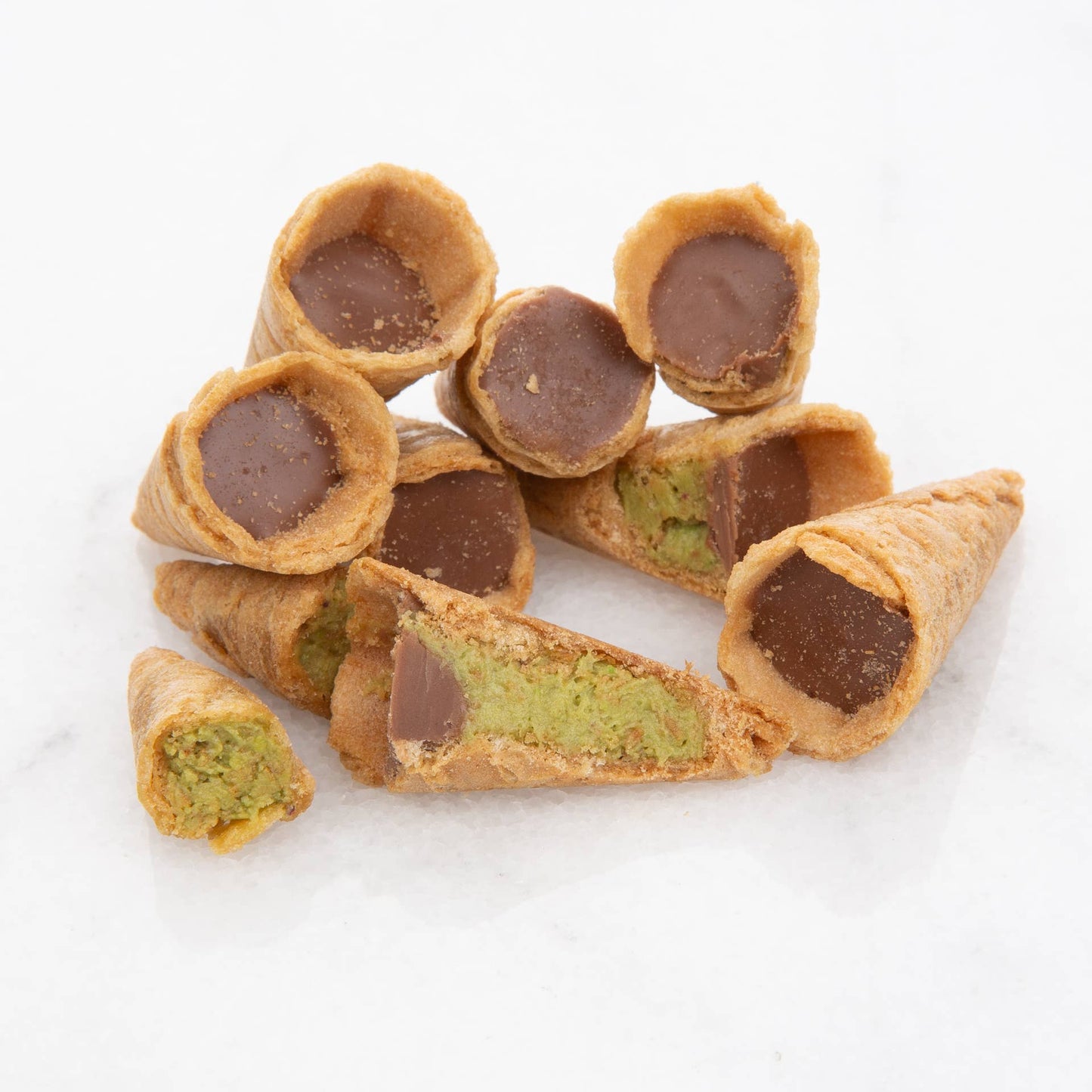 Confectionery items with chocolate and green filling on a white background