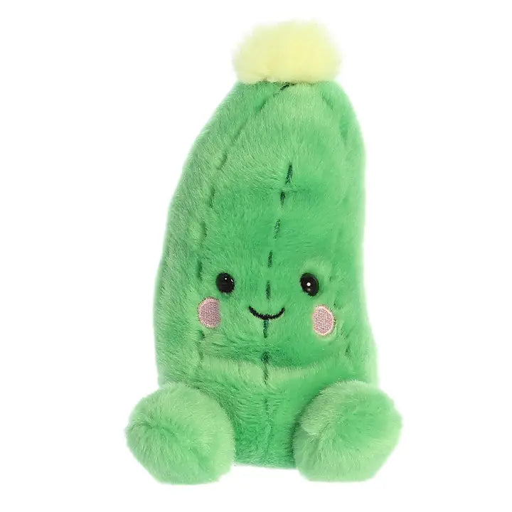 Green plush cucumber toy with a happy face on a white background