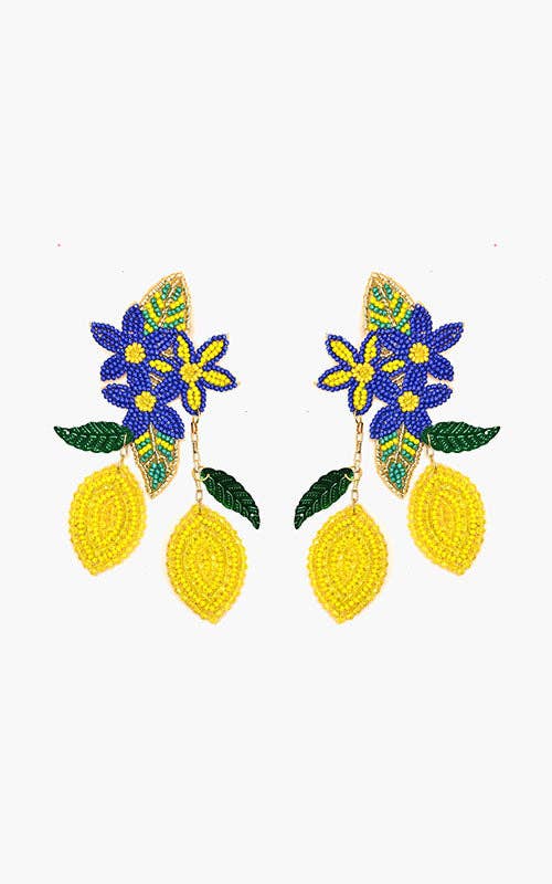 Pair of earrings with floral and lemon designs on a white background