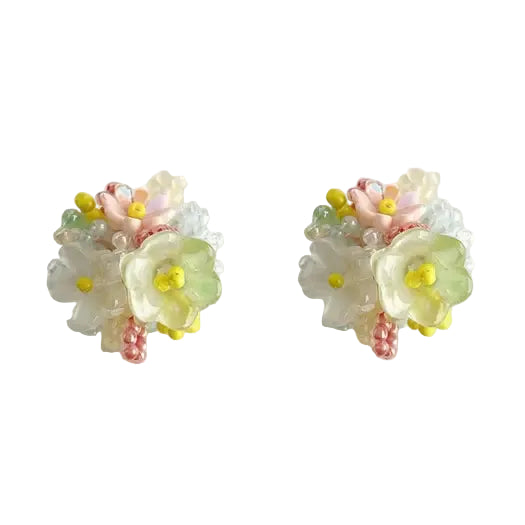 Two beaded earrings that resemble a bouquet of yellow, white and pink flowers on a white background