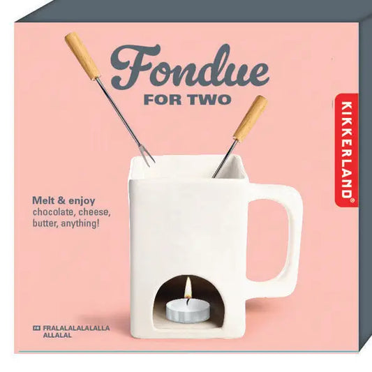 Kikkerland fondue set packaging with a white fondue pot and two skewers on a pink background.