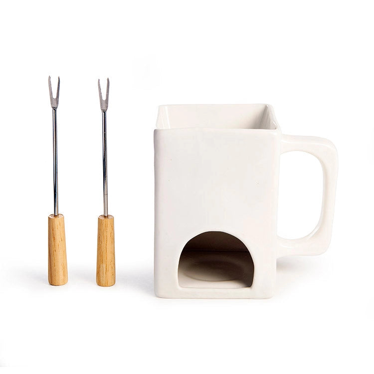 White ceramic mug with a small opening, accompanied by two metal skewers with wooden handles on a white background.