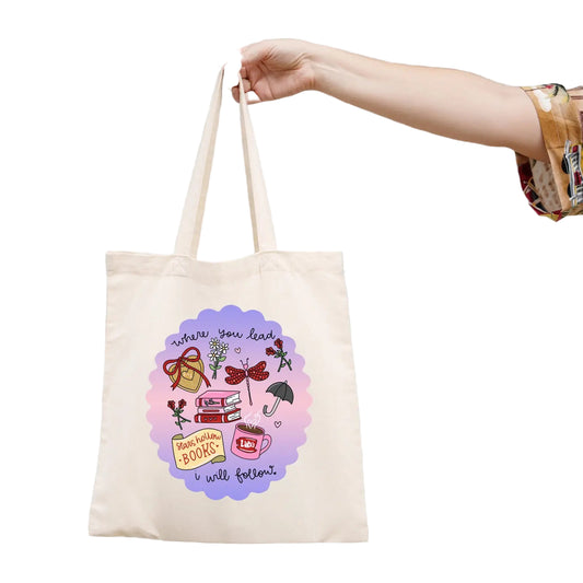 Tote bag with colorful design and text held by a hand