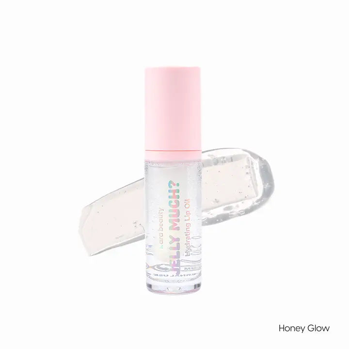 The Honey Glow color of Jelly Much lip oil is shown (it is clear),along with the packaging which is a tube with wand and pink lid.