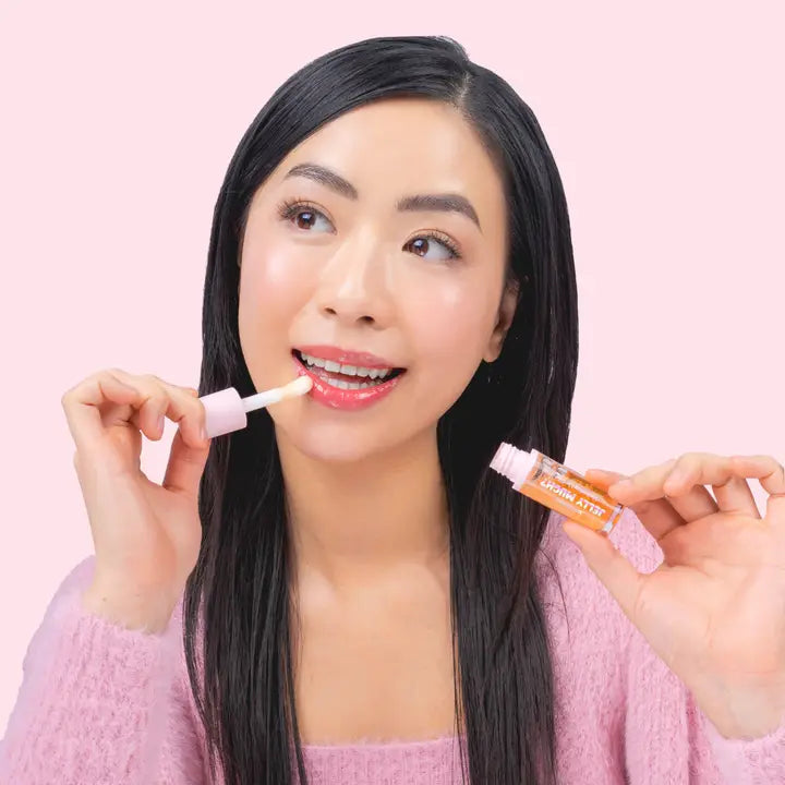 a model wearing the mango color of Jellly Much Lip balm