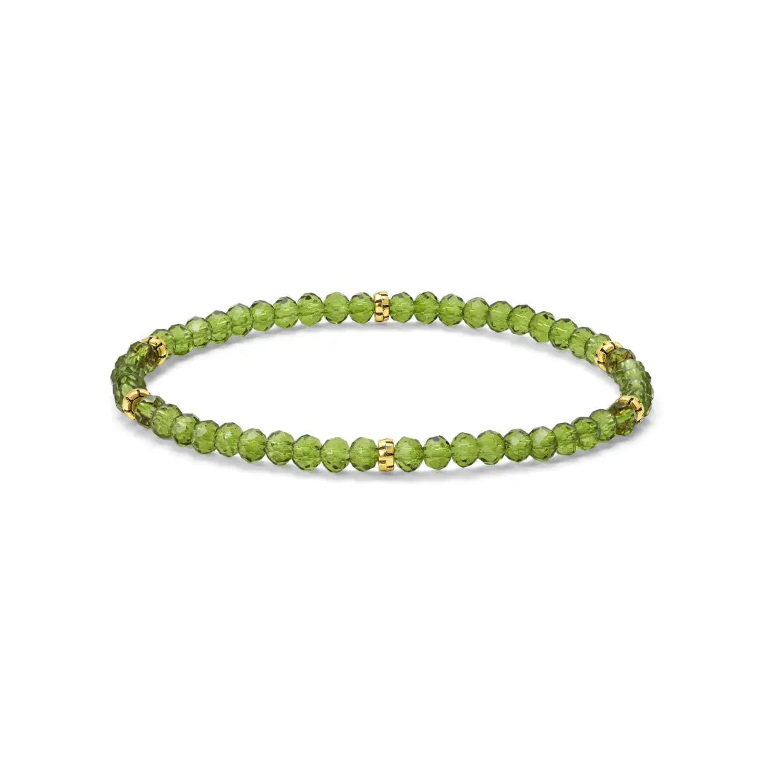 Peridot green beaded bracelet with gold accents on a white background