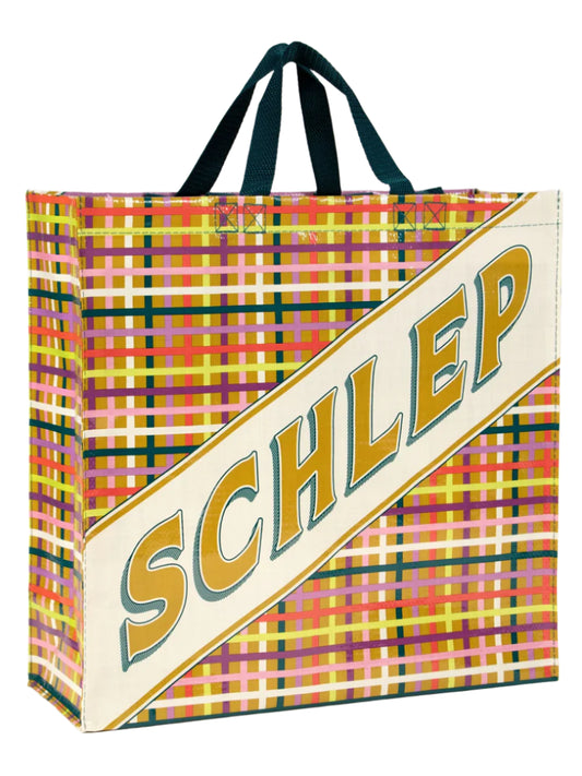 Colorful plaid bag with 'SCHLEP' text on a white background