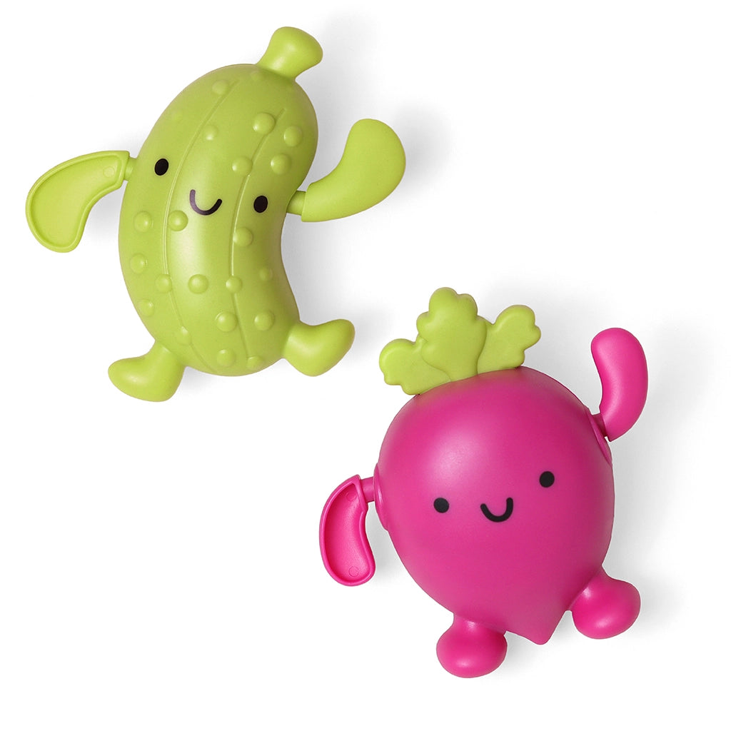 Two colorful toy vegetables, one pickle and one beet