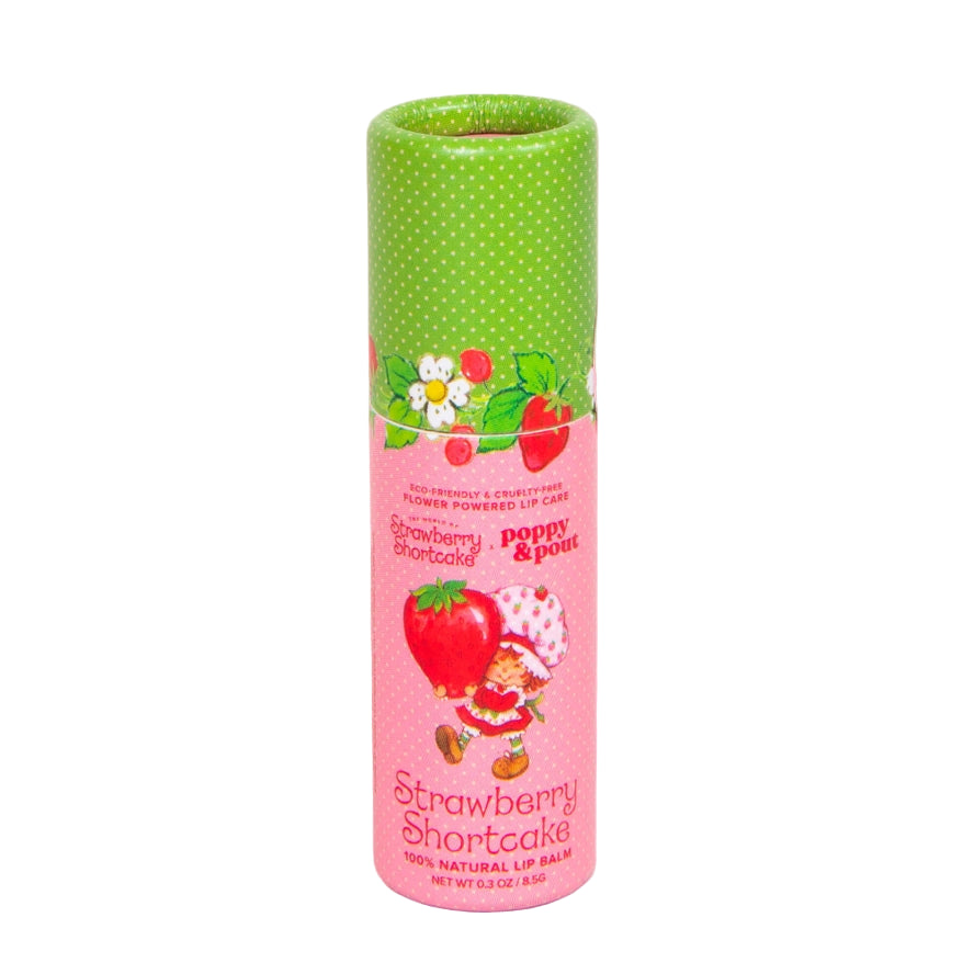 Lip balm packaging with a pink label and green top on a pink background