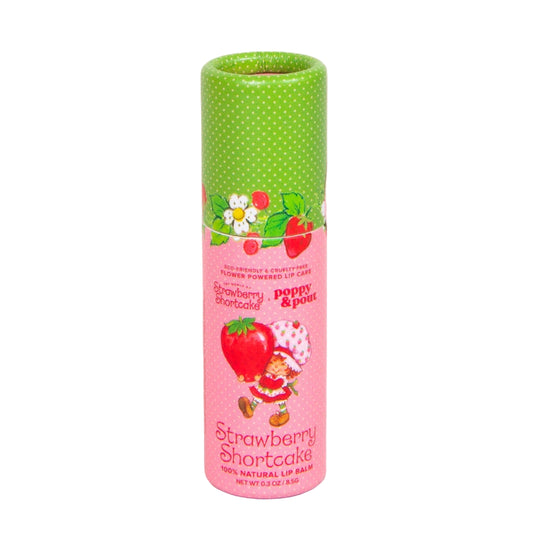 Lip balm packaging with a pink label and green top on a pink background