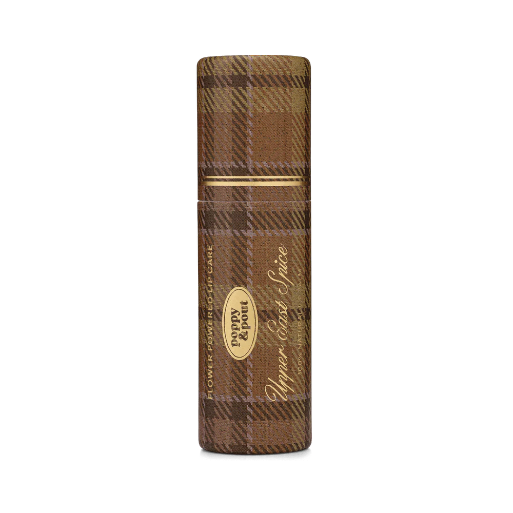 Brown plaid lip balm with gold accents on a white background