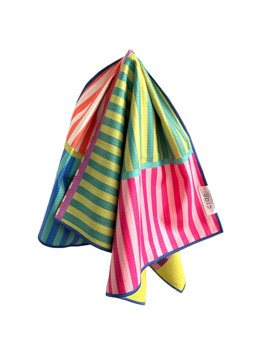 Colorful striped towel with a brand label on a white background