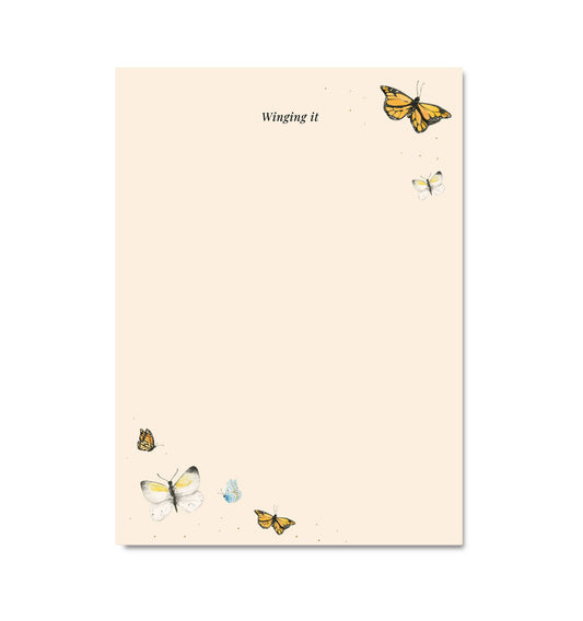 Notebook with butterfly illustrations and 'Winging it' text on a beige background