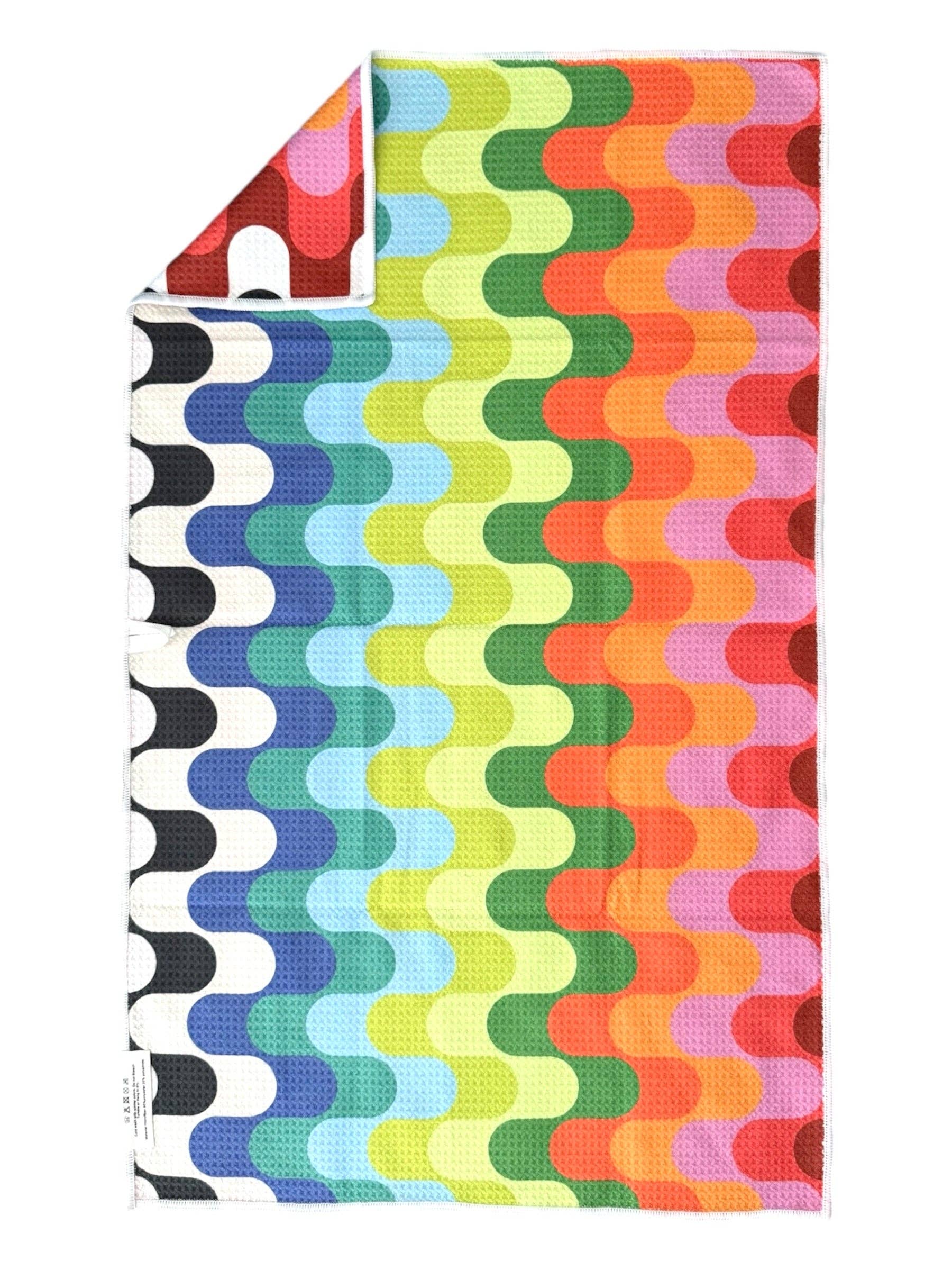 Colorful patterned towel with wavy design on a white background