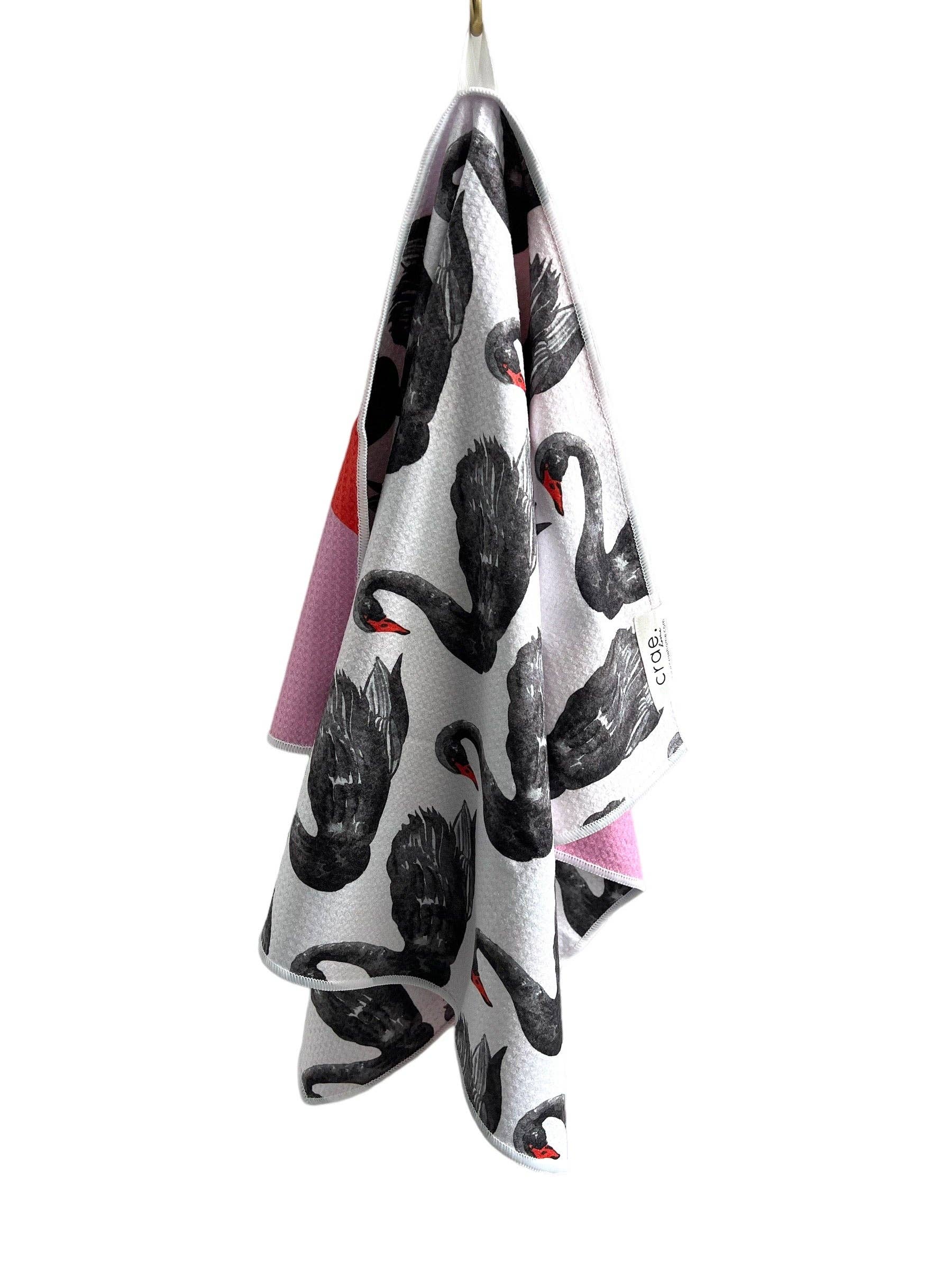 Towel with black and white pattern hanging on a white background