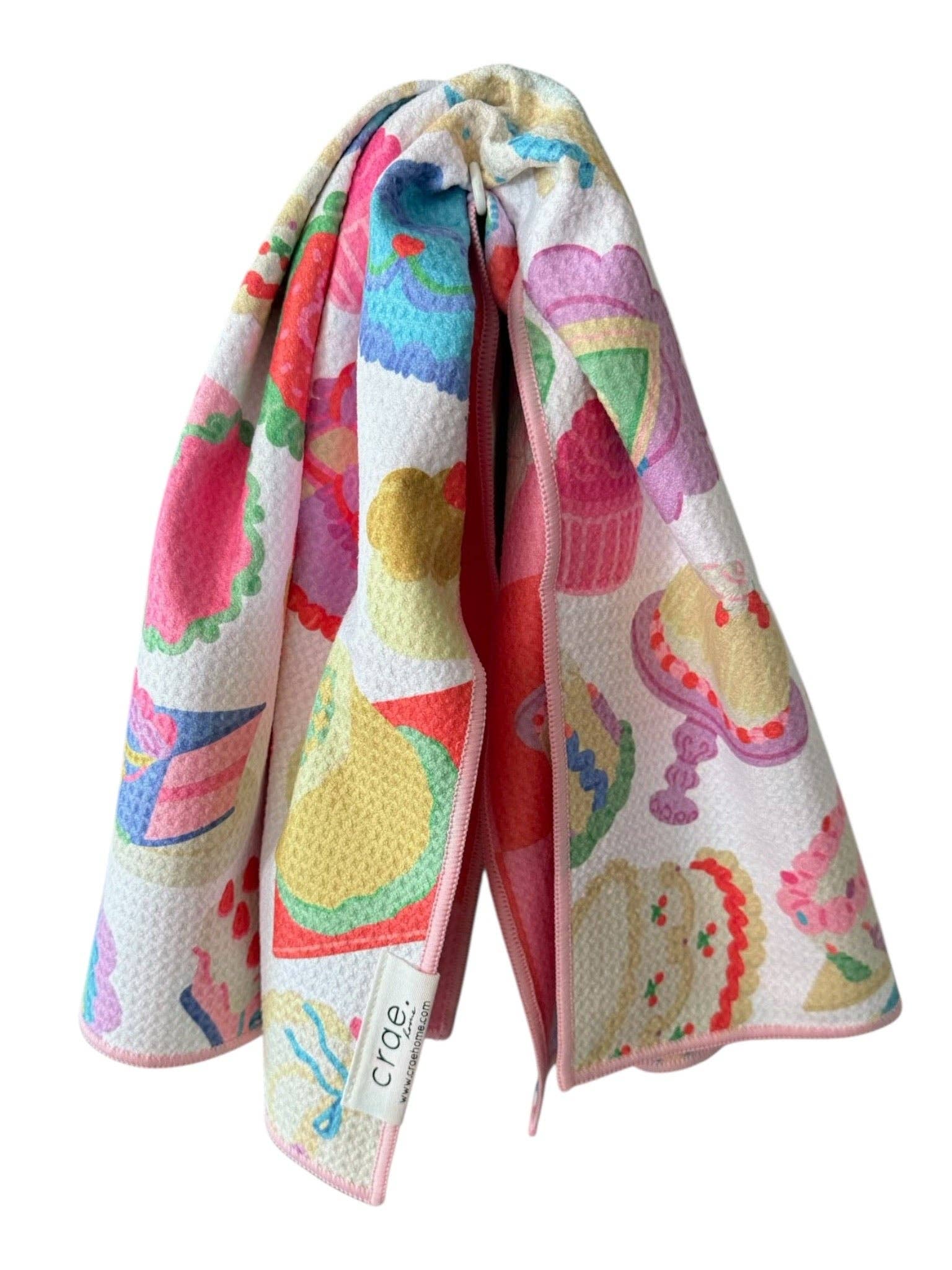 Colorful kitchen towel with cupcake design on a white background