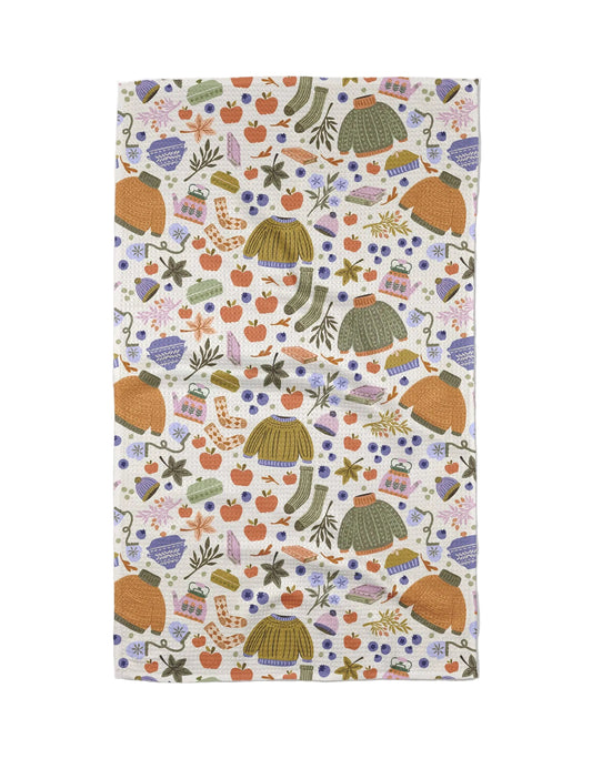 Patterned tea towel with autumn-themed design on a white background