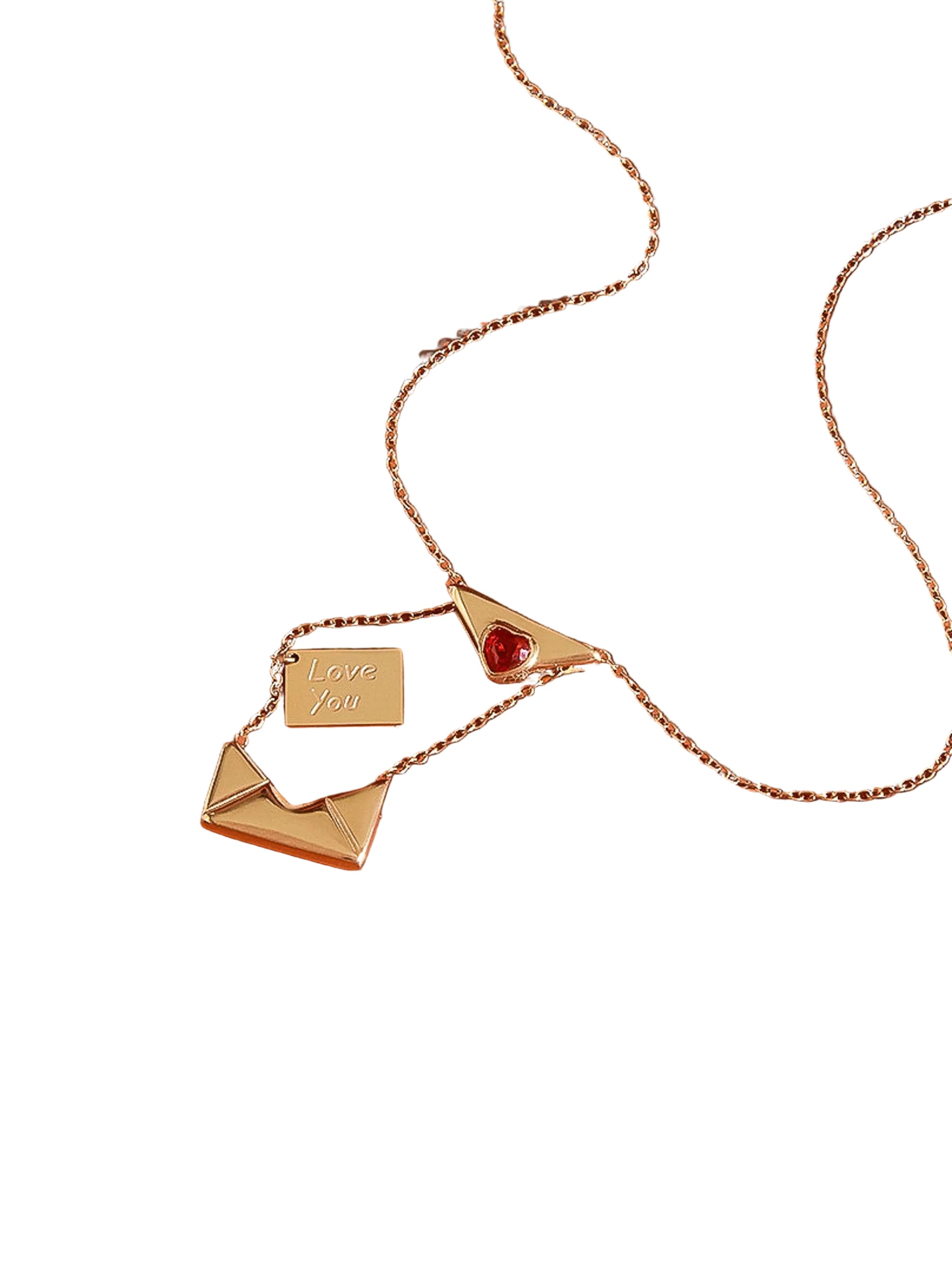 Gold necklace with heart and envelope charms on a white background