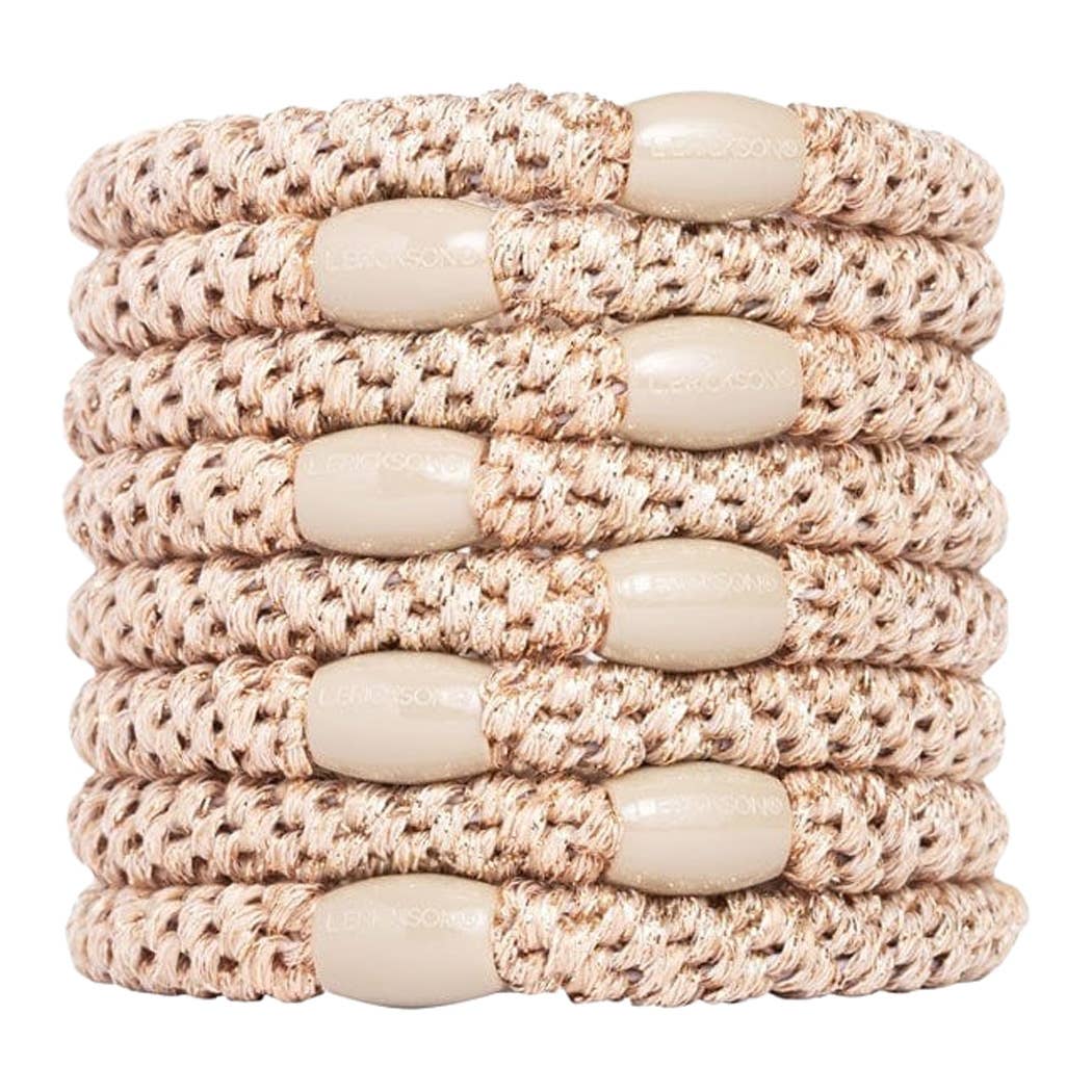 Stack of beige crochet hairbands with wooden beads on a white background