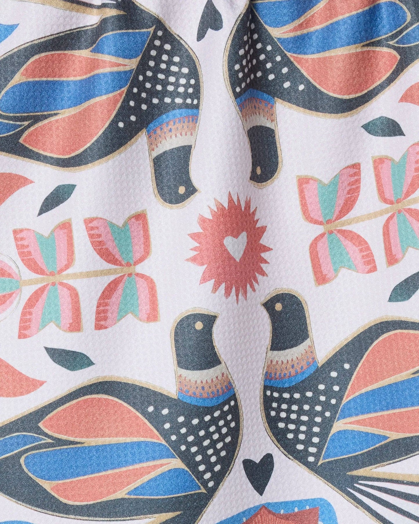 White tea towel with symmetrical pink, blue, gold, and dark grey birds and flowers design 