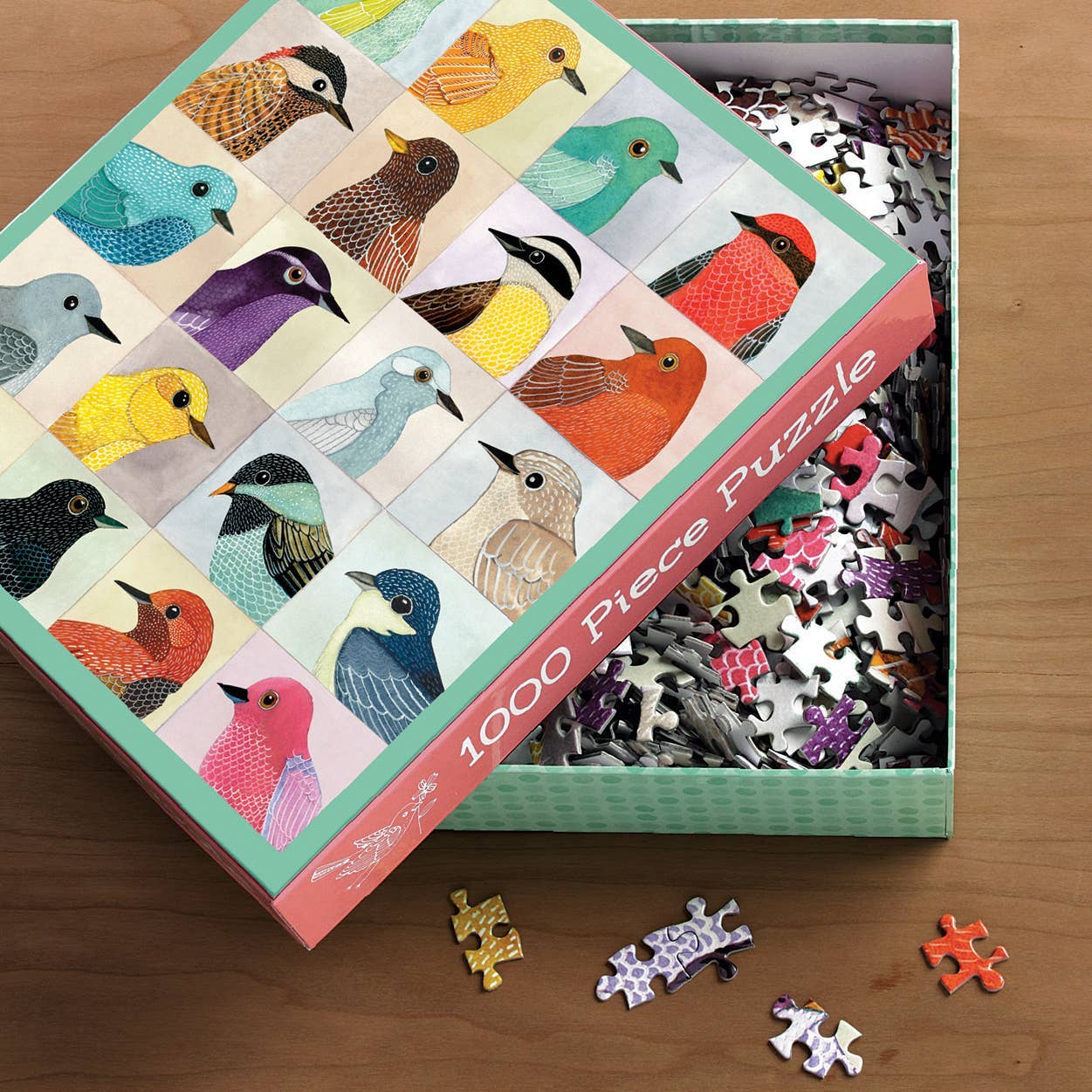 Jigsaw puzzle box with bird illustrations on a wooden surface