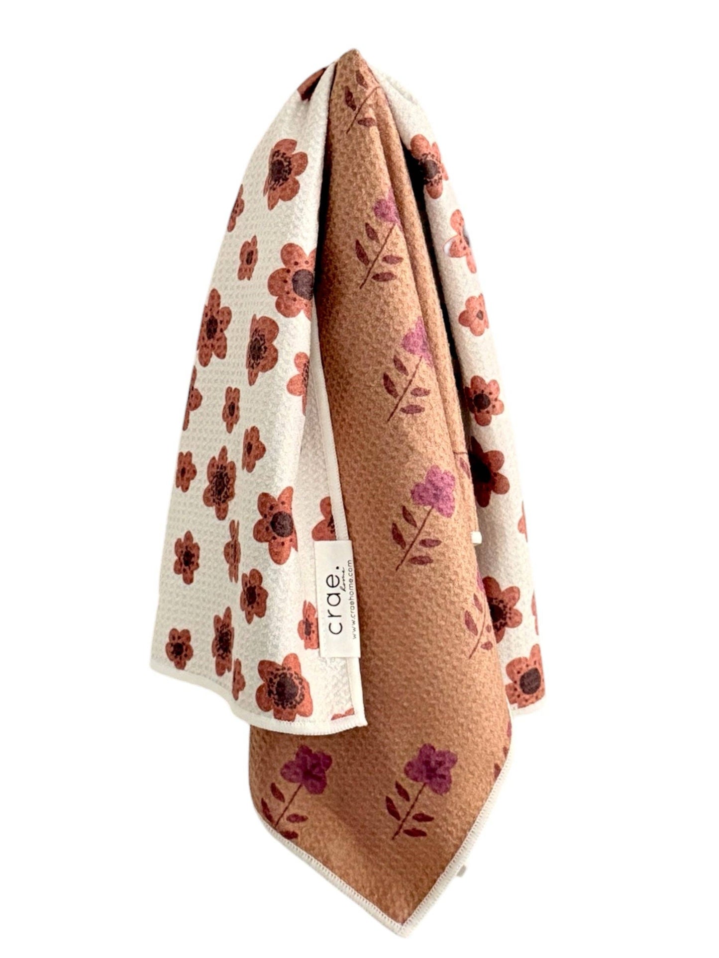 Floral-patterned baby blanket with a visible brand logo on a white background