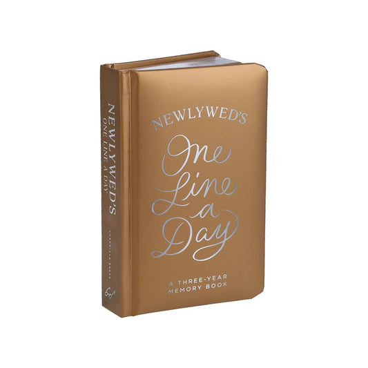 Gold book titled 'Newlywed's One Line a Day' on a white background