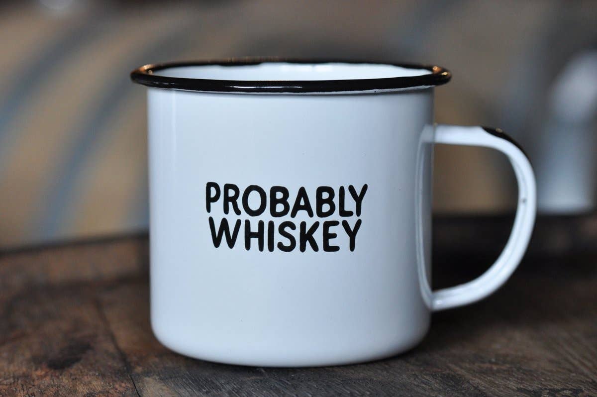 White mug with 'PROBABLY WHISKEY' text on a wooden surface