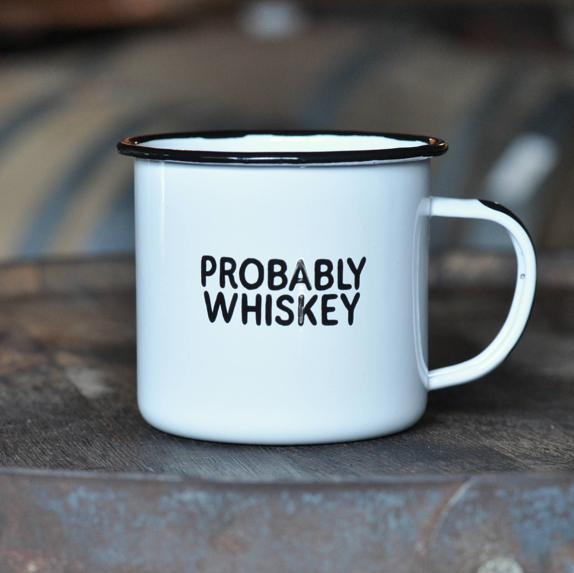 White mug with 'PROBABLY WHISKEY' text on a wooden surface