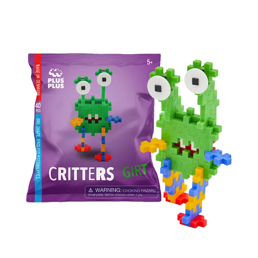 Green toy figure with colorful legs next to a purple packaging labeled 'Plus Plus Critters'.