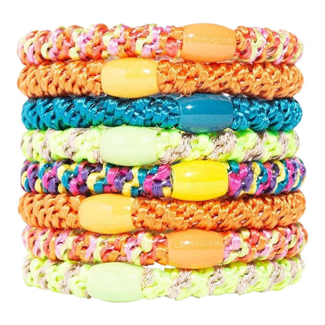 Stack of colorful braided bracelets with multicolored beads on a white background