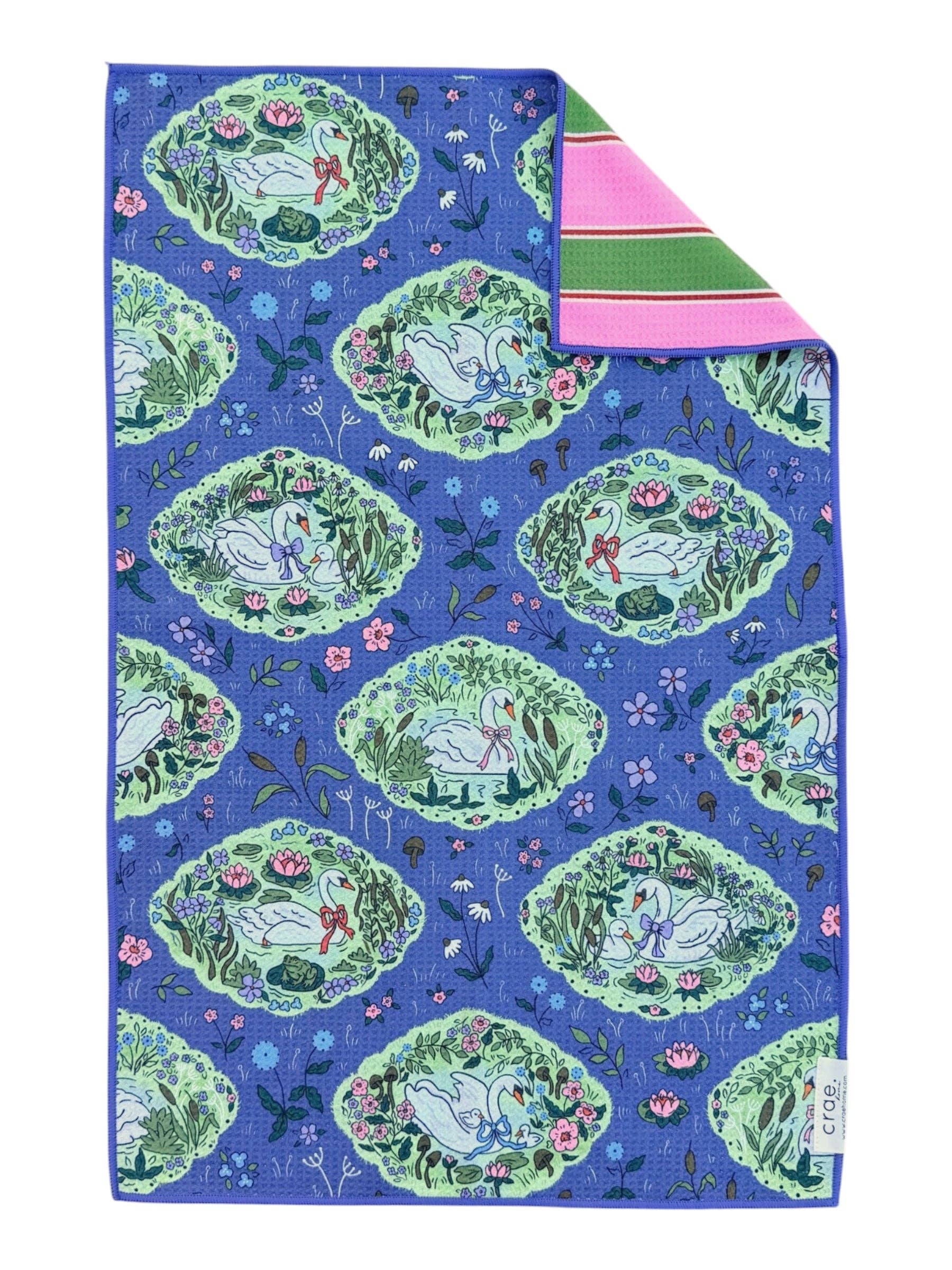 Colorful fabric with a pattern of green animals and flowers on a blue background