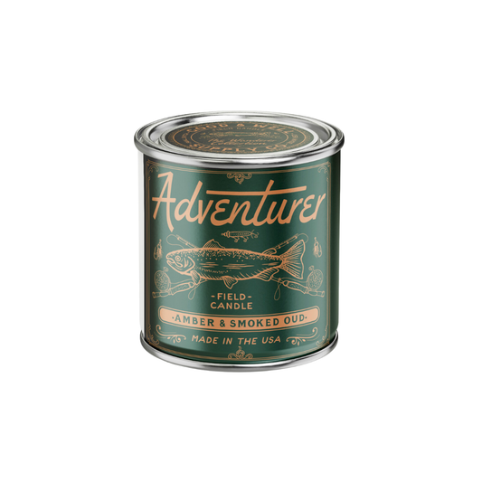 Candle canister labeled 'Adventures' with fish illustration on a white background