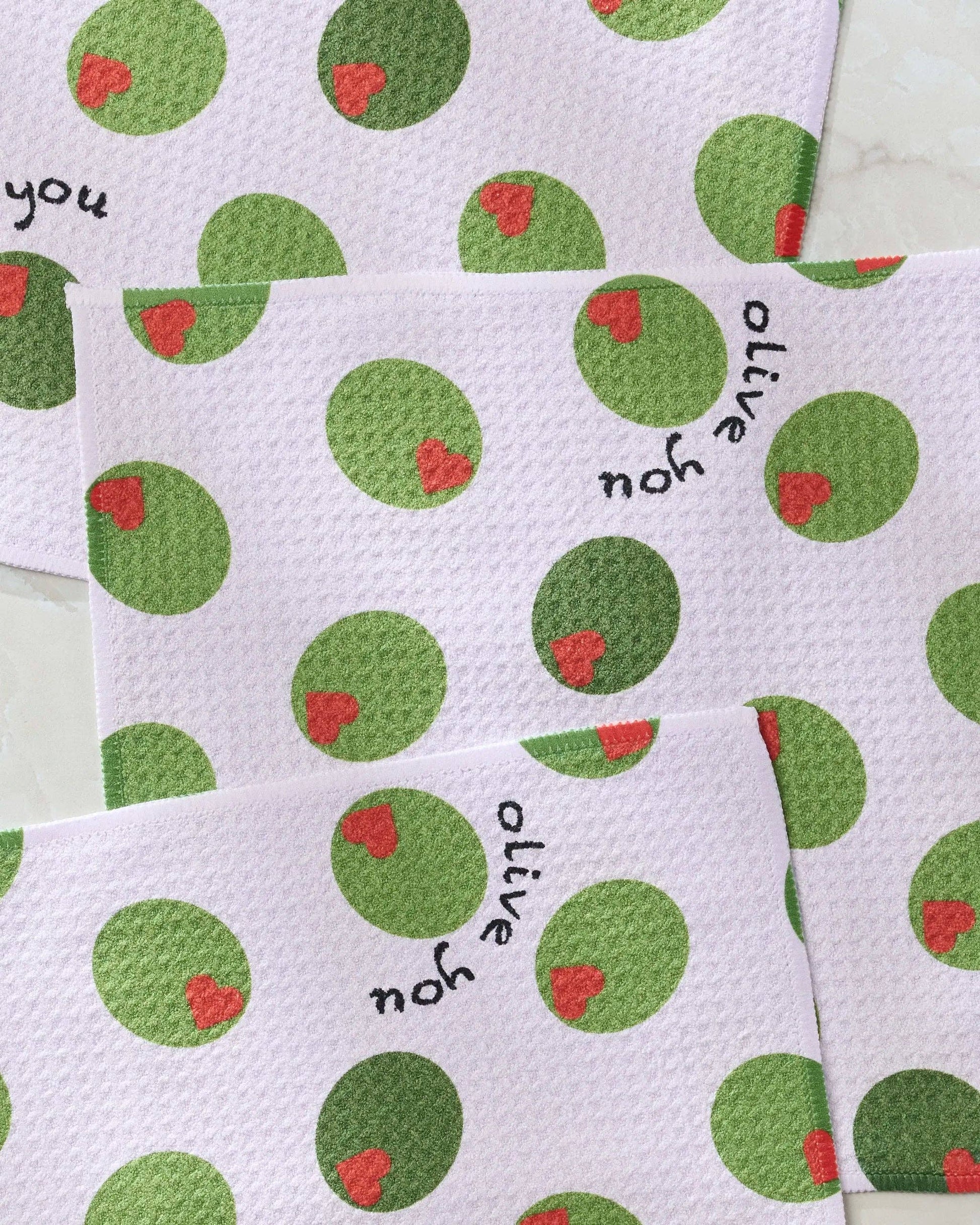 White dish towels with green olives pattern with "Olive You" text 