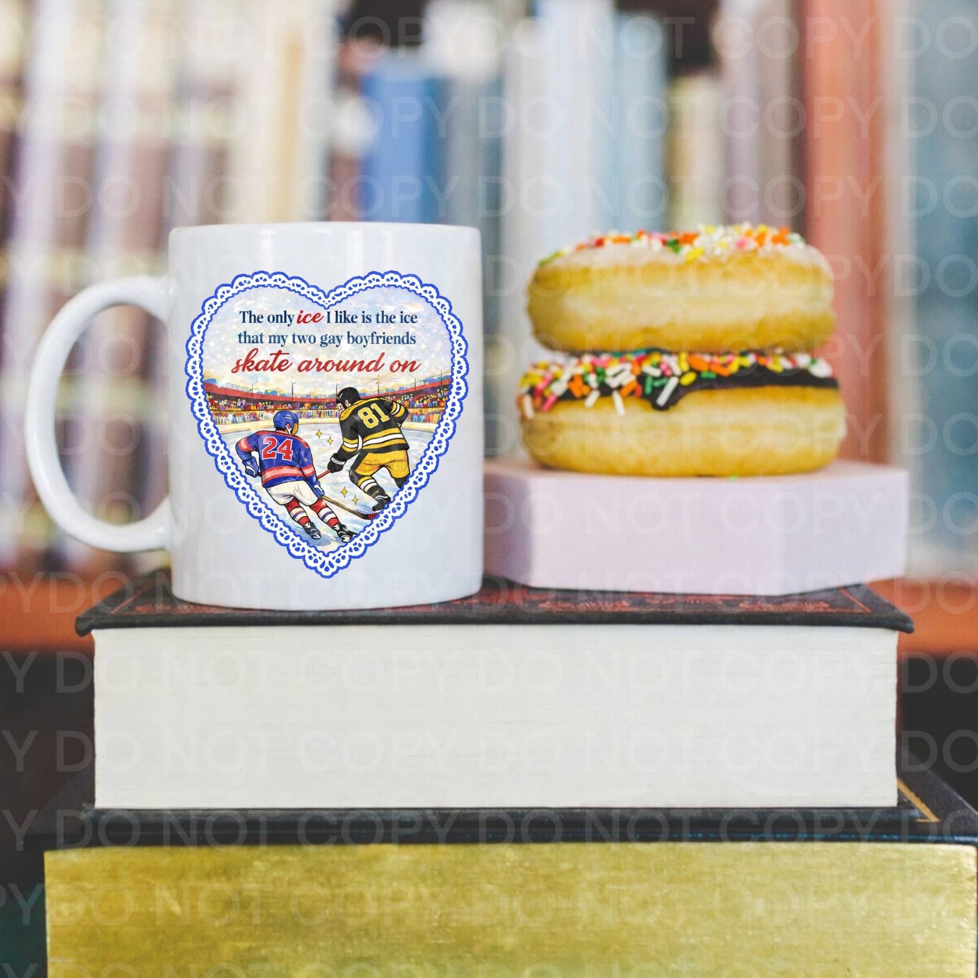 Mug with hockey design on a stack of books with donuts in the background