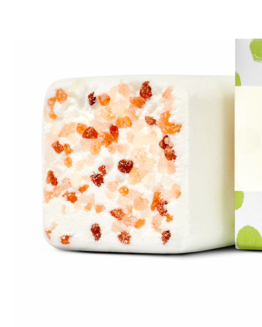 Bath bomb with Himalayan salt crystals inside on a white background