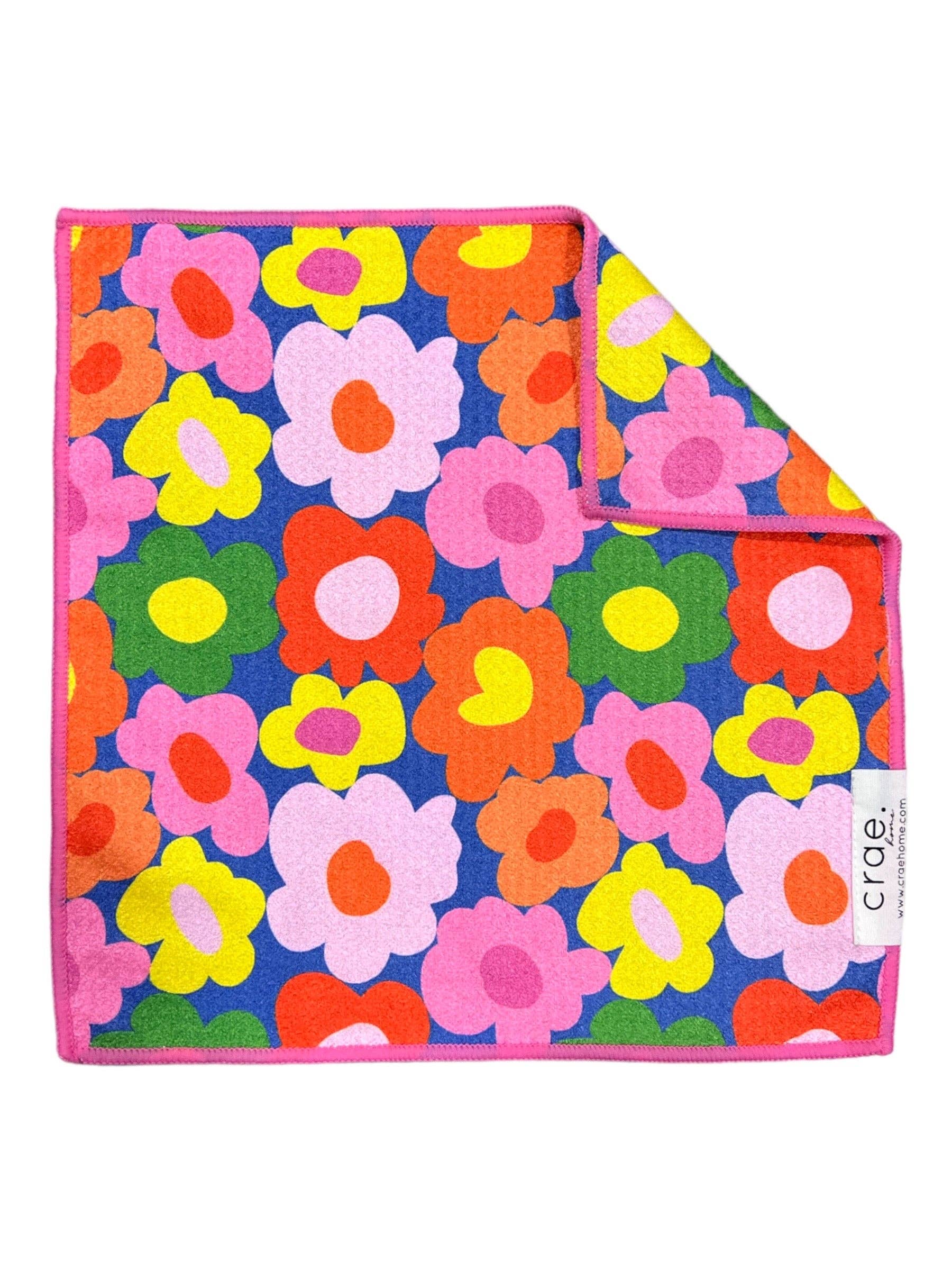 Colorful floral patterned blanket with 'Crae' branding on a white background
