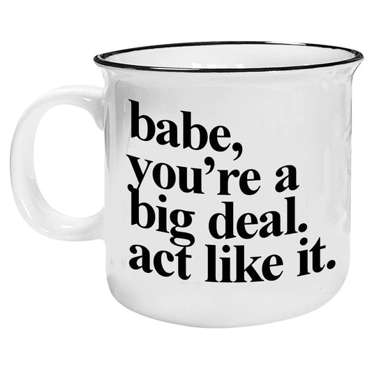 White mug with black text on a white background