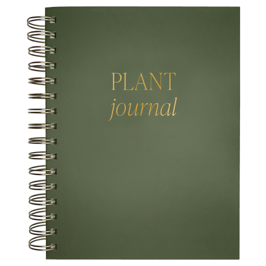 Green spiral-bound notebook with 'Plant Journal' text on a white background
