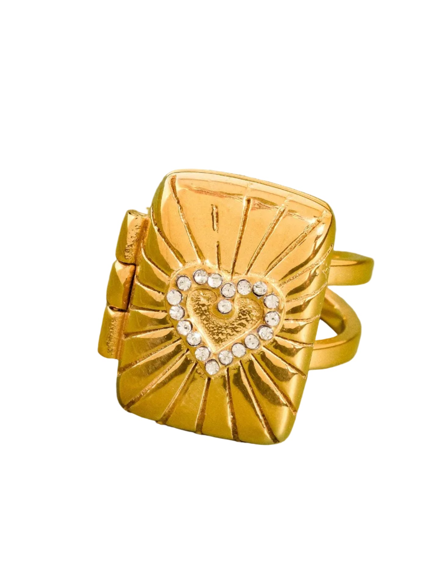 Gold ring with heart design on a green background
