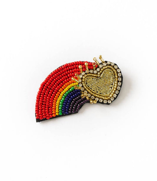Beaded rainbow and heart-shaped brooch on a white background